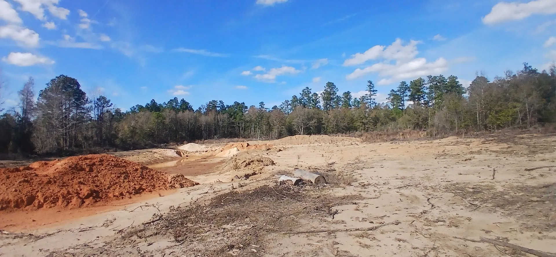 Red clay bank running along the pit floor