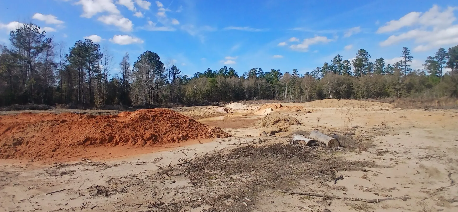Red clay bank under a blue sky