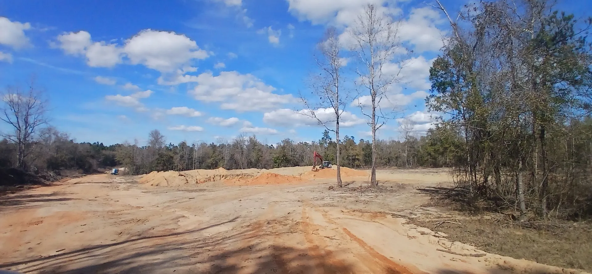 A cut face of red clay in the pit