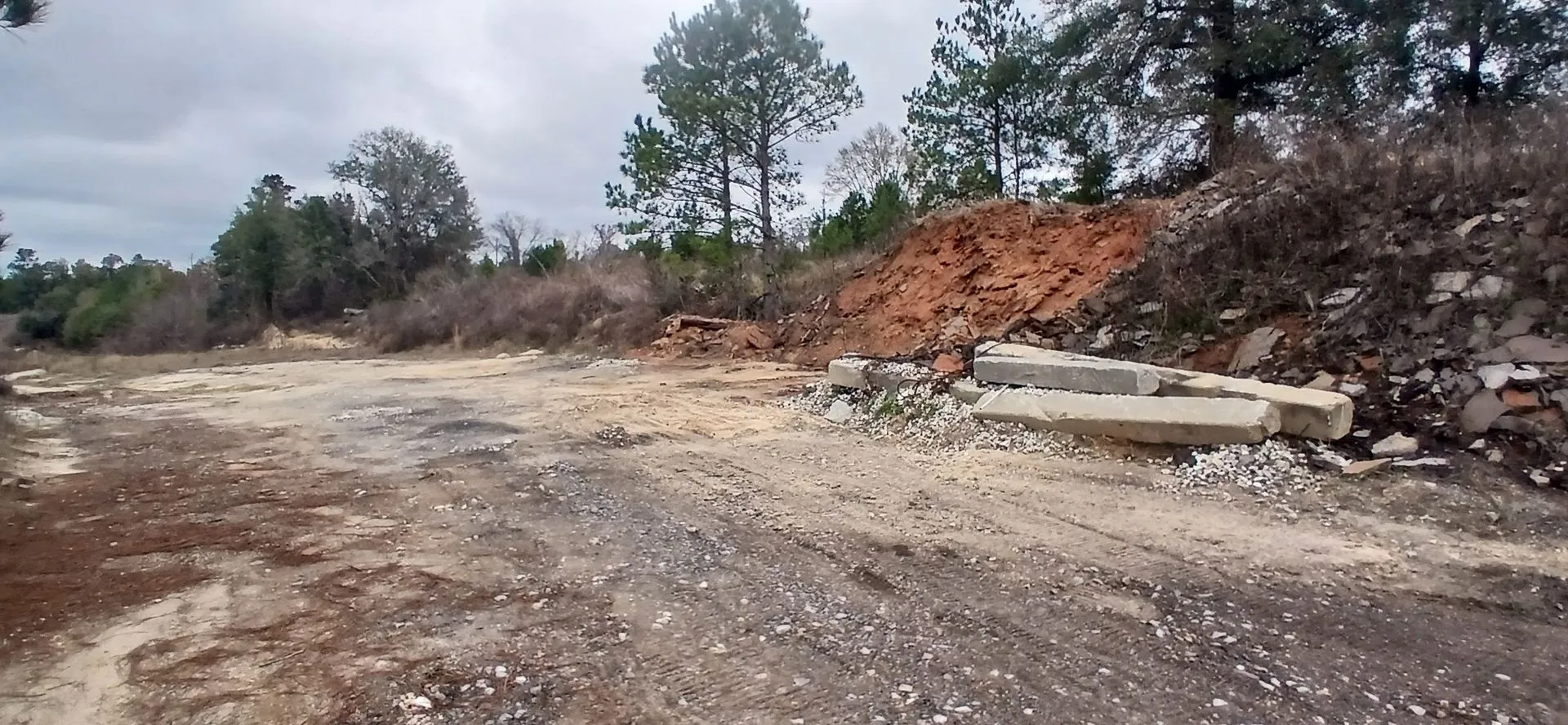 Stockpiled material and land debris at the site