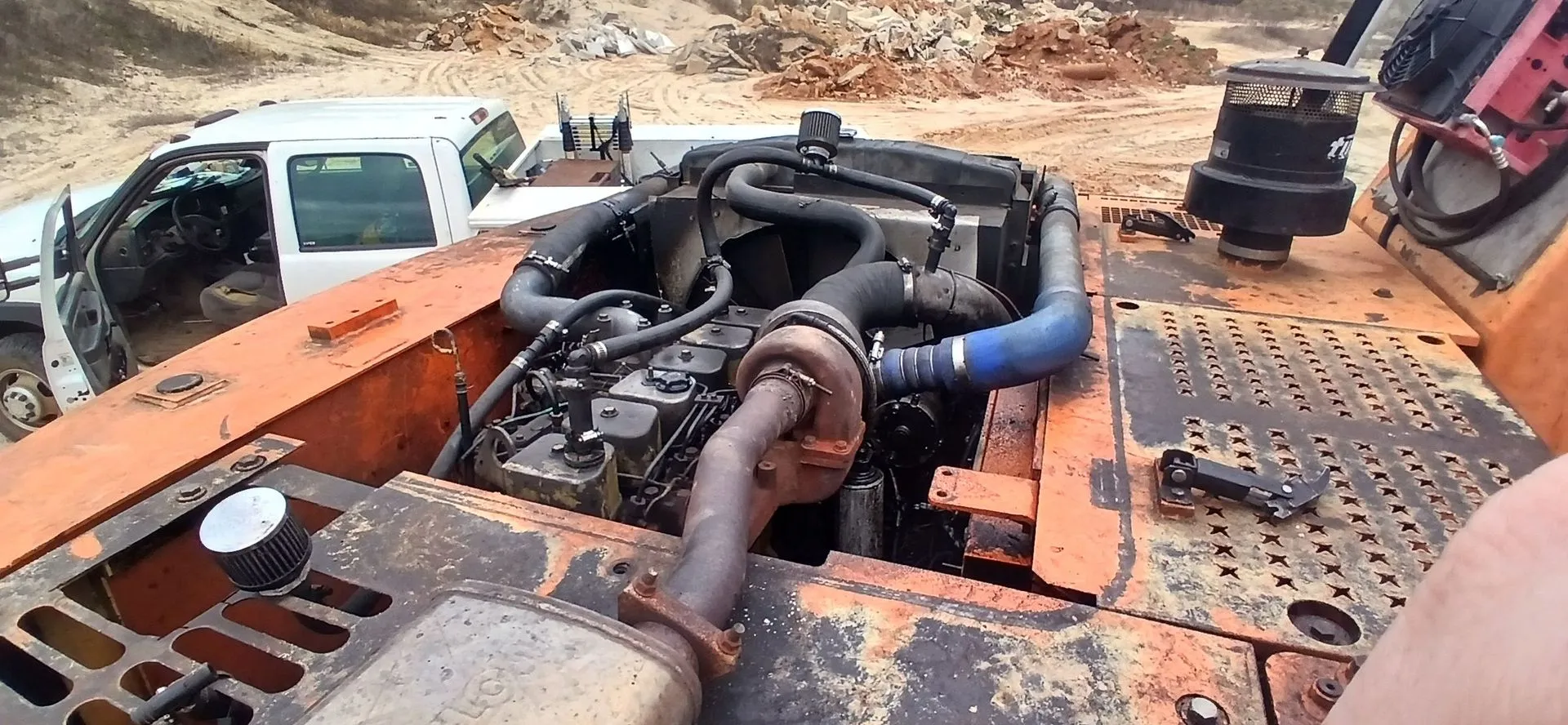 Engine bay of a machine mid-repair in the Baxley shop
