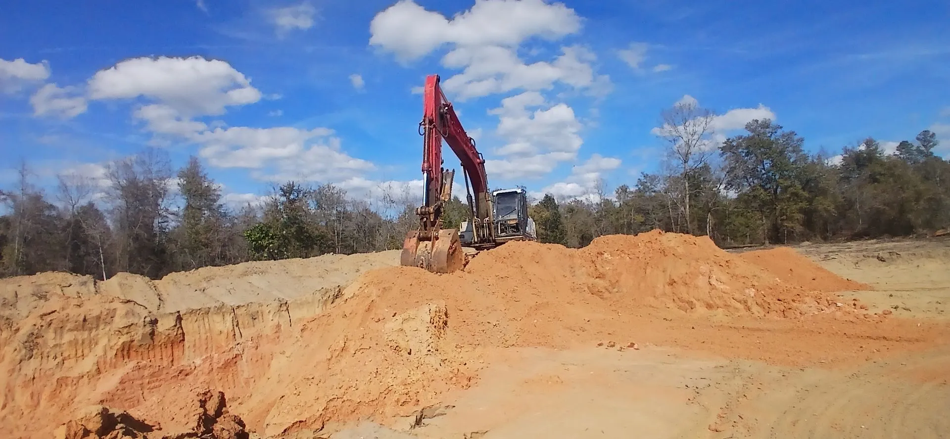 Excavator working on top of the pit ridge